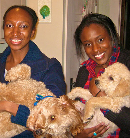 My two friends holding a mother dog and her almost grown puppy