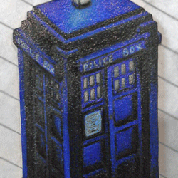 Shrinky Dink pendant of a blue Tardis / police call box drawn with prisma color pencils