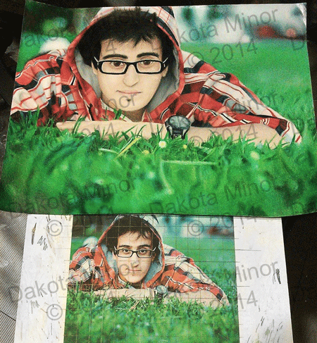 prisma color pencil drawing of a boy with glasses in a red plad jacket laying in the grass