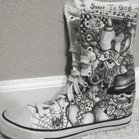 white high top shoe with black sharpie ink drawings on it