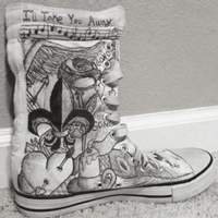 white high top shoe with black sharpie ink drawings on it